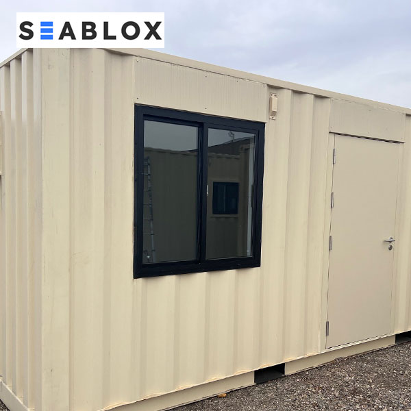 Shipping container window installed in container wall