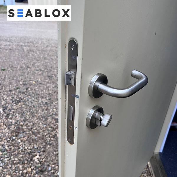 Deadbolt lock and interior handle system on shipping container man door in Texas
