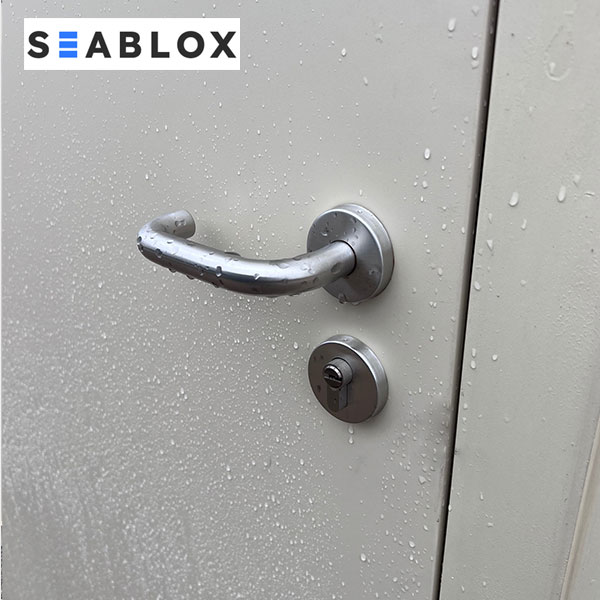 Weather-resistant lock and handle system on shipping container man door in Texas